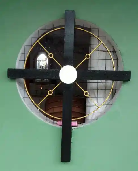 Cross with rays on a circular window.